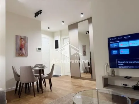 Living room with dining area, seating and a built-in mirrored wardrobe. - image 6