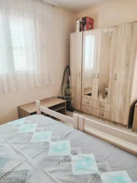 Furnished bedroom with a large wardrobe and a window. - image 6