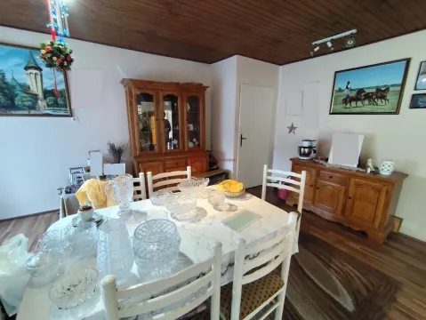 Dining room with wooden furniture and a dining table. - image 19