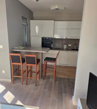 Modern kitchen with a breakfast bar and wooden bar stools. - image 5