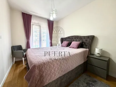 Furnished bedroom with a double bed, armchair, and nightstand. - image 10