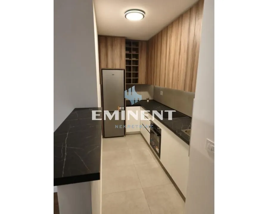 Modern kitchen with wooden elements and built-in appliances.