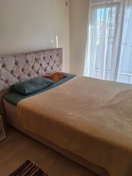 Bedroom with a double bed and a bright window. - image 5