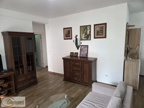Living room with sofa, wooden furniture and pictures on the wall. - image 5