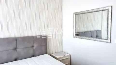Furnished bedroom with a double bed, wallpaper, and a wall mirror. - image 7