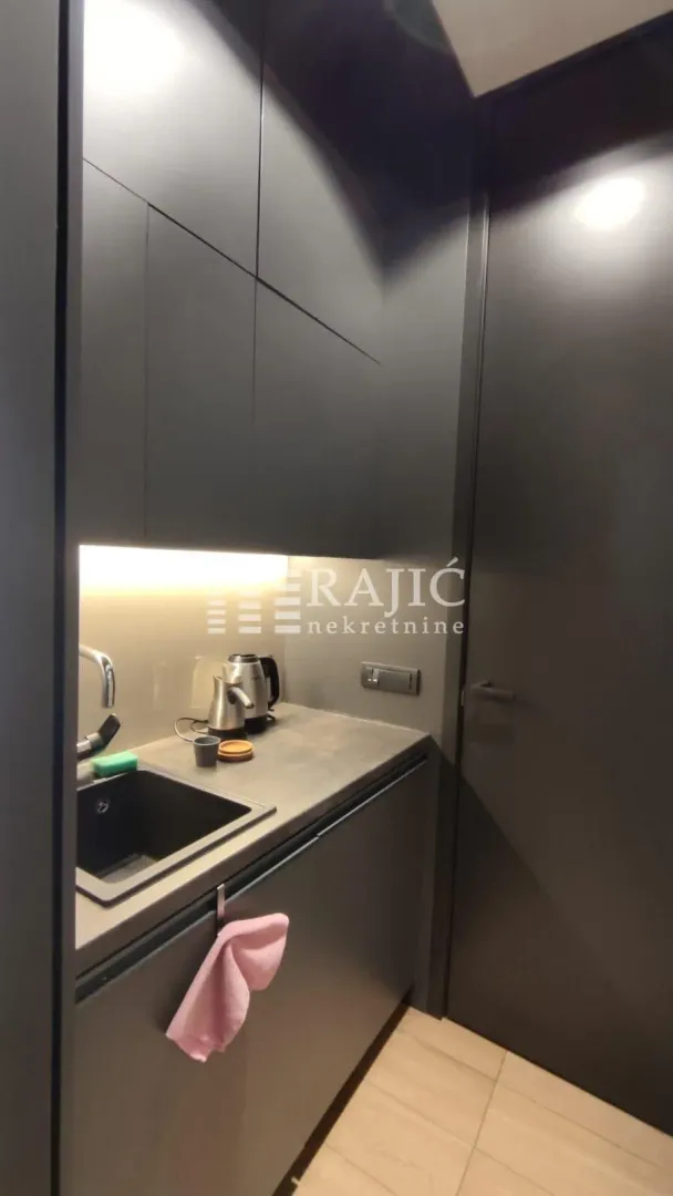 Modern black kitchen with a sink and built-in units.