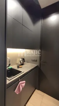 Modern black kitchen with a sink and built-in units. - image 9