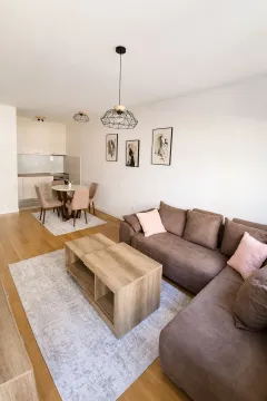 Modern and bright living room with dining area and kitchen. - image 2