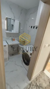 Modernly equipped bathroom with a washing machine. - image 4