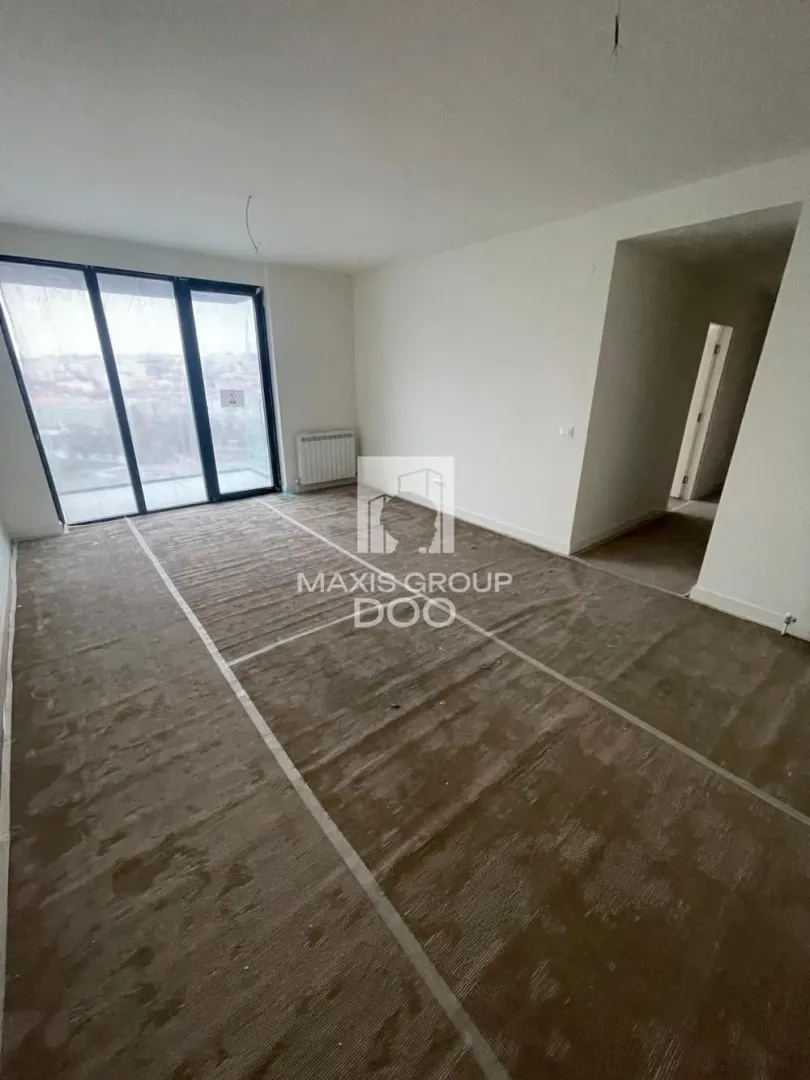 Empty unfurnished room with glass balcony doors.