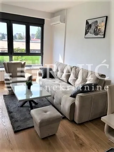 Living room with a sofa, armchair, and coffee table.