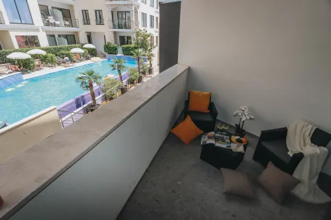 Furnished terrace with seating area and a view of the swimming pool. - image 9