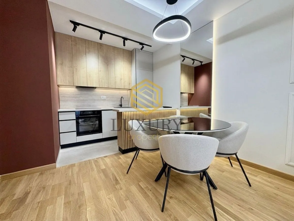 Modern kitchen with dining area and built-in appliances.
