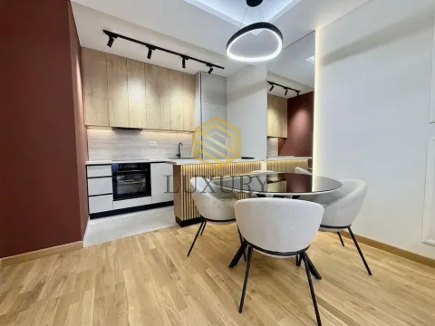 Modern kitchen with dining area and built-in appliances. - image 3
