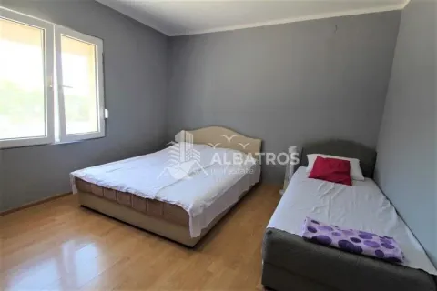 Bedroom with a double bed and an additional single bed, grey walls, and wooden flooring. - image 8