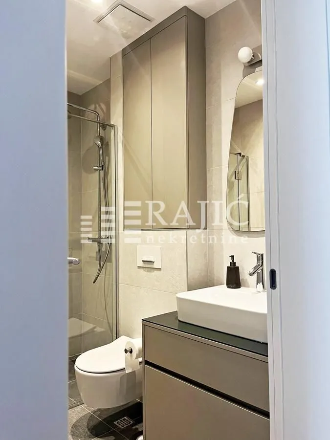 Modern equipped bathroom with a shower cabin.