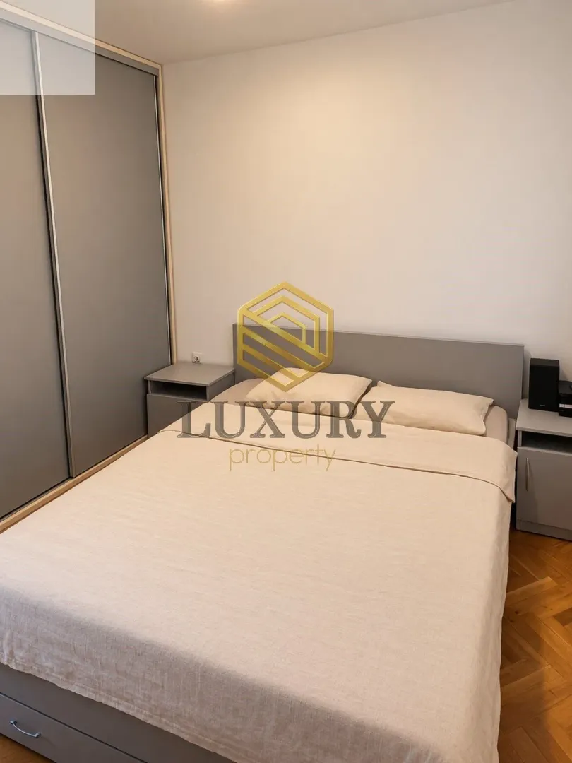 Bedroom with a double bed, wardrobe, and nightstands.