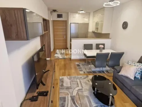 Living room with a dining area and kitchen in the background. - image 3