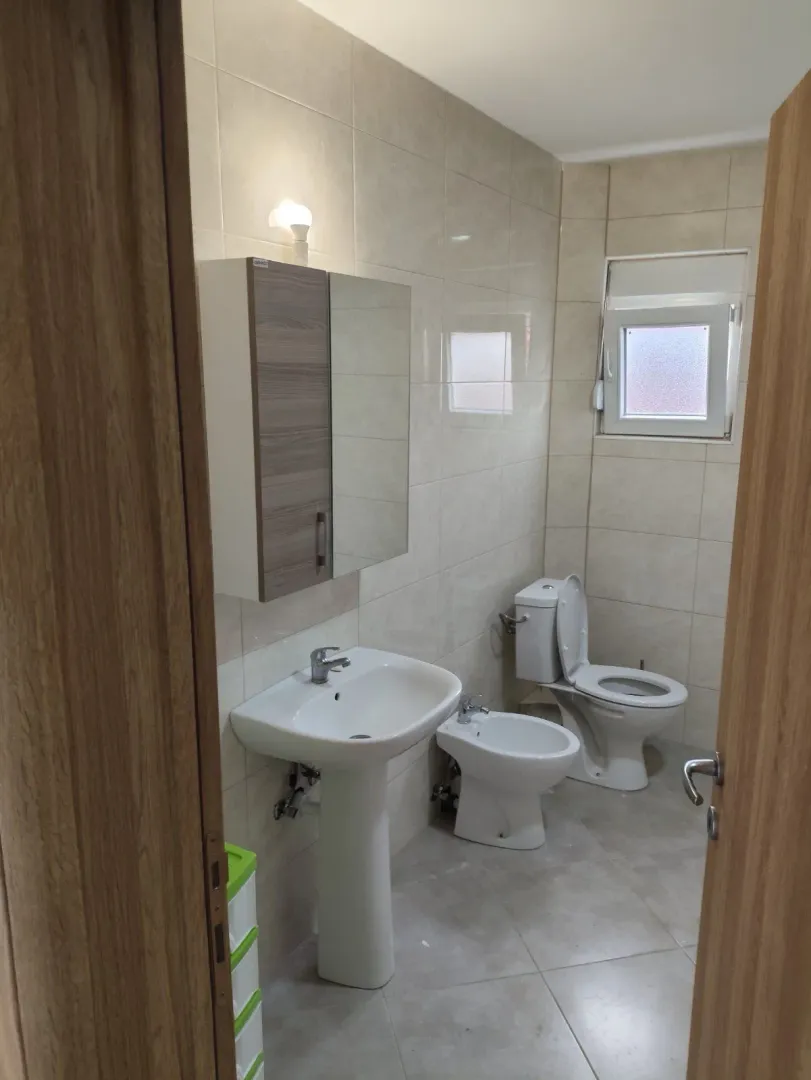 Bright bathroom featuring a sink, bidet, and toilet.