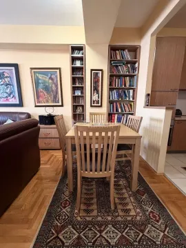 Dining area with a wooden table and chairs, connected to the living room and kitchen. - image 4