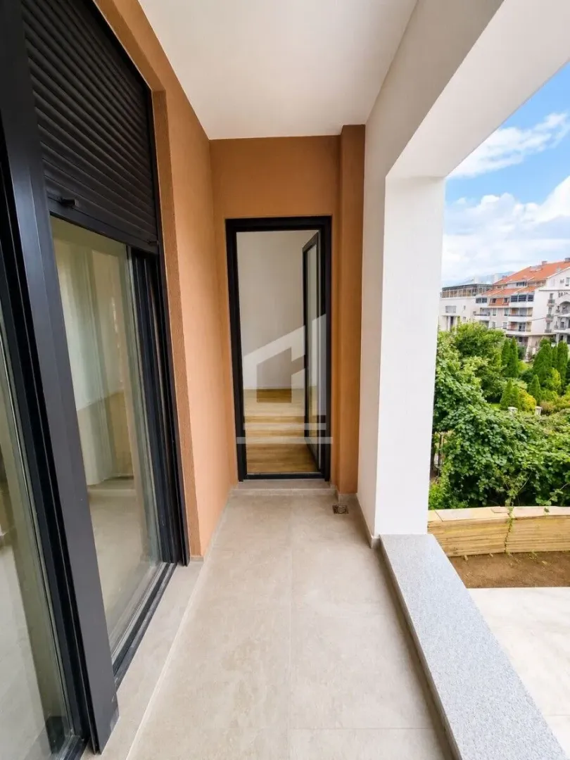 Covered balcony with a view of the courtyard and surrounding buildings.