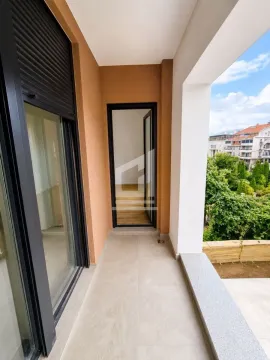 Covered balcony with a view of the courtyard and surrounding buildings. - image 7
