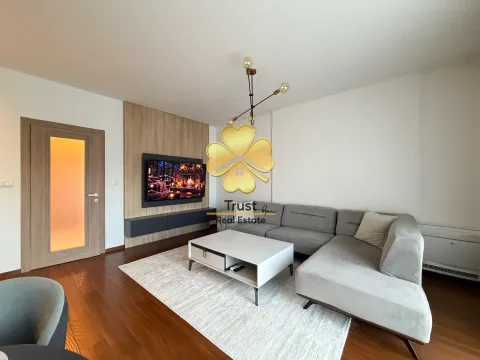 Modern living room with a sofa, coffee table, and wall-mounted TV. - image 4