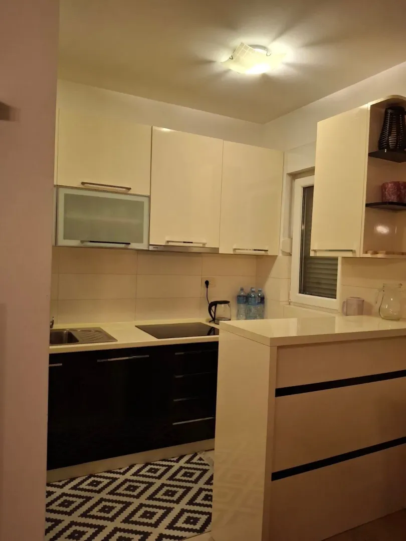 Modern kitchen with light cabinets and a breakfast bar.