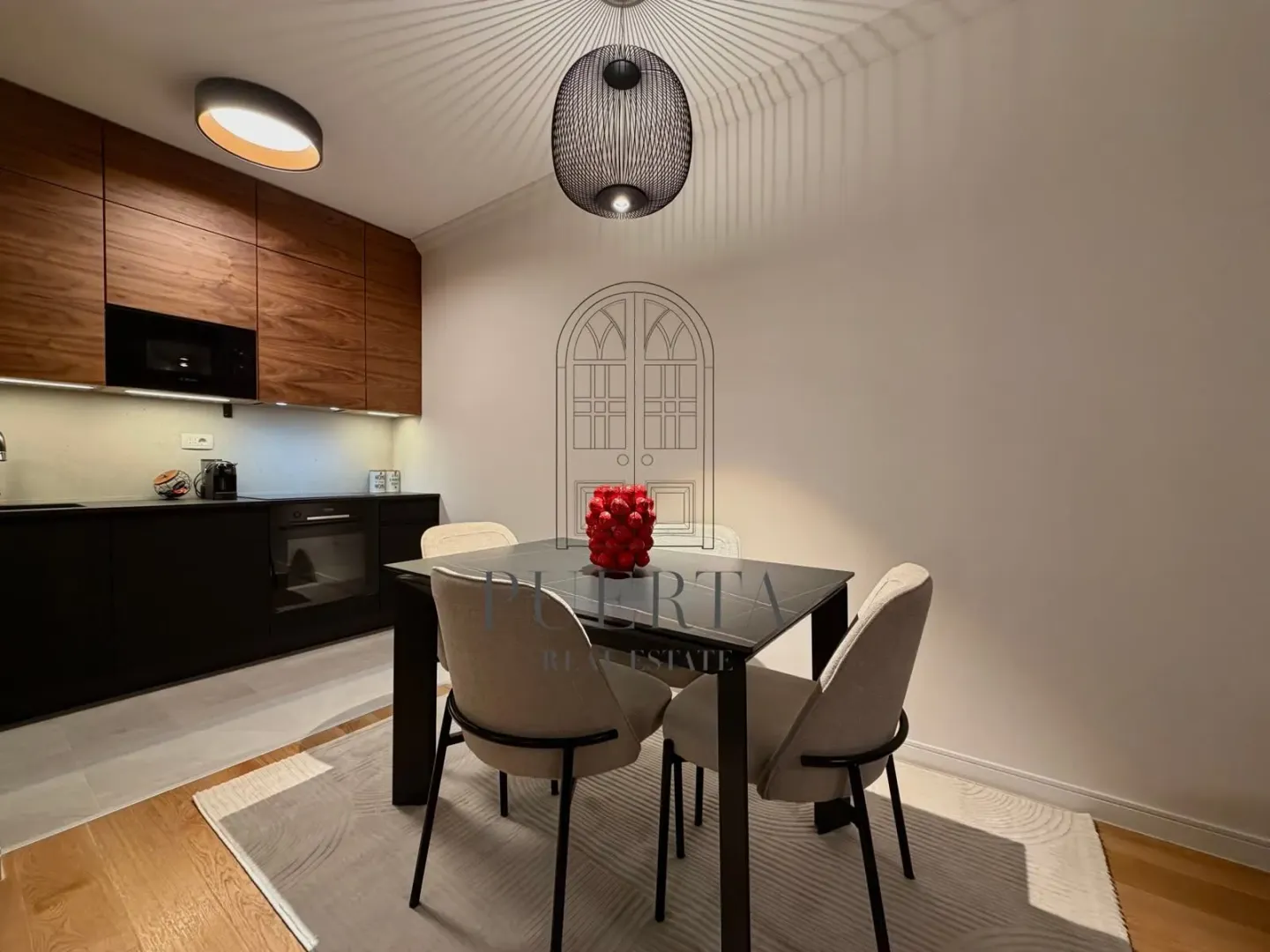 Modern kitchen with dining table and chairs.