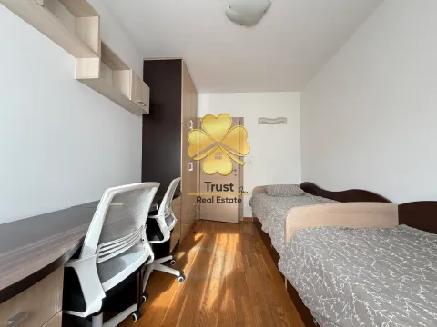 Furnished bedroom with two beds and a desk. - image 14