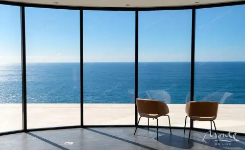 Sea view through a large glass wall with two chairs. - image 9