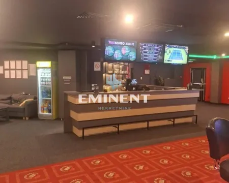 Interior of the commercial space with a counter and wall screens. - image 5