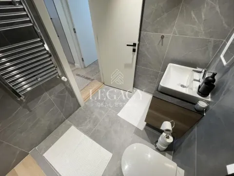 Modernly equipped bathroom with a shower cabin, washbasin, and toilet. - image 9