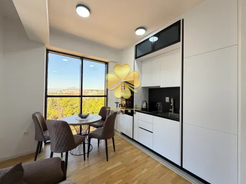 Modern kitchen with a dining area and a large window offering a view of nature. - image 6