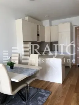 Dining area connected to a modernly equipped kitchen. - image 4