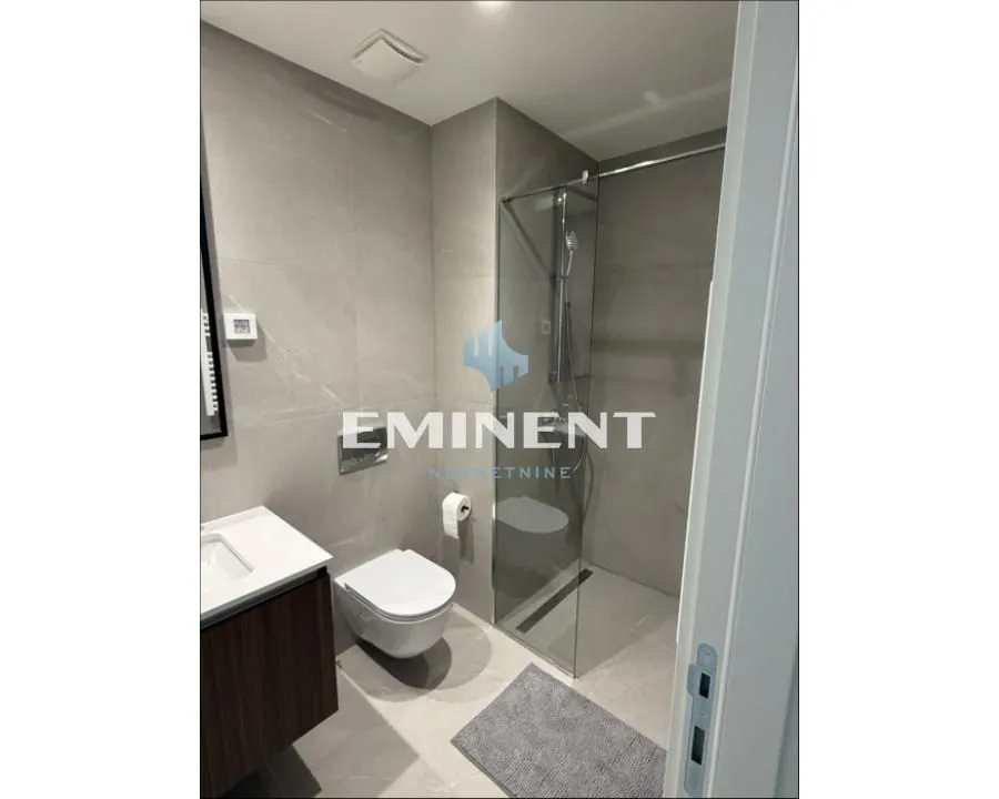 Modern bathroom with a walk-in shower and built-in sanitary ware.