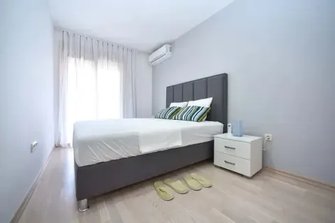 Bedroom with a double bed, nightstand, and air conditioning unit. - image 7