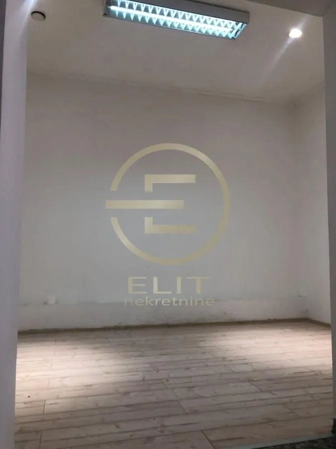 Empty unfurnished room with white walls and wooden flooring.