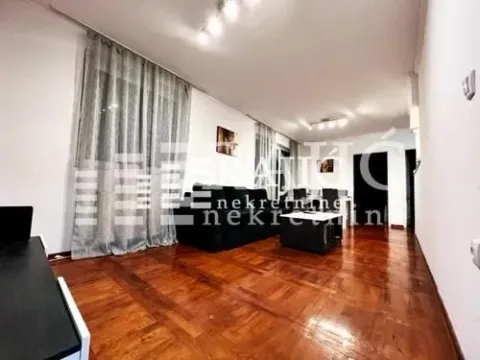 Spacious living room with a sofa set and wooden parquet flooring. - image 2
