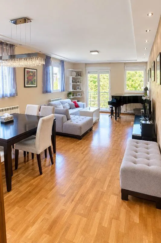 Spacious living room with a dining area and a piano.