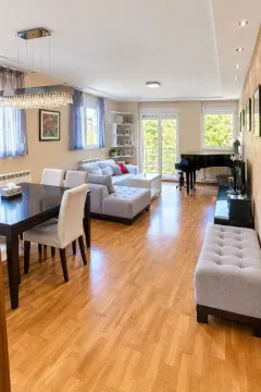 Spacious living room with a dining area and a piano. - image 3