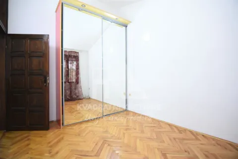 Empty bedroom with a large fitted mirrored wardrobe and hardwood flooring. - image 9