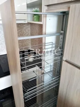 View of a pull-out pantry unit inside kitchen cabinets. - image 13