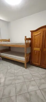 Bedroom with a bunk bed and a wooden wardrobe. - image 10