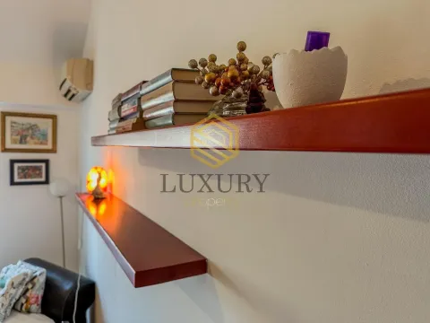 Interior detail showing wooden wall shelves and books. - image 6
