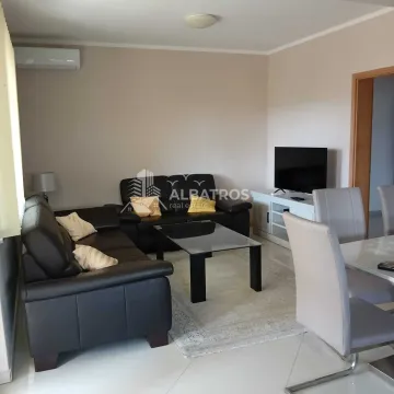 Living room with a sofa set, television, and dining table. - image 2