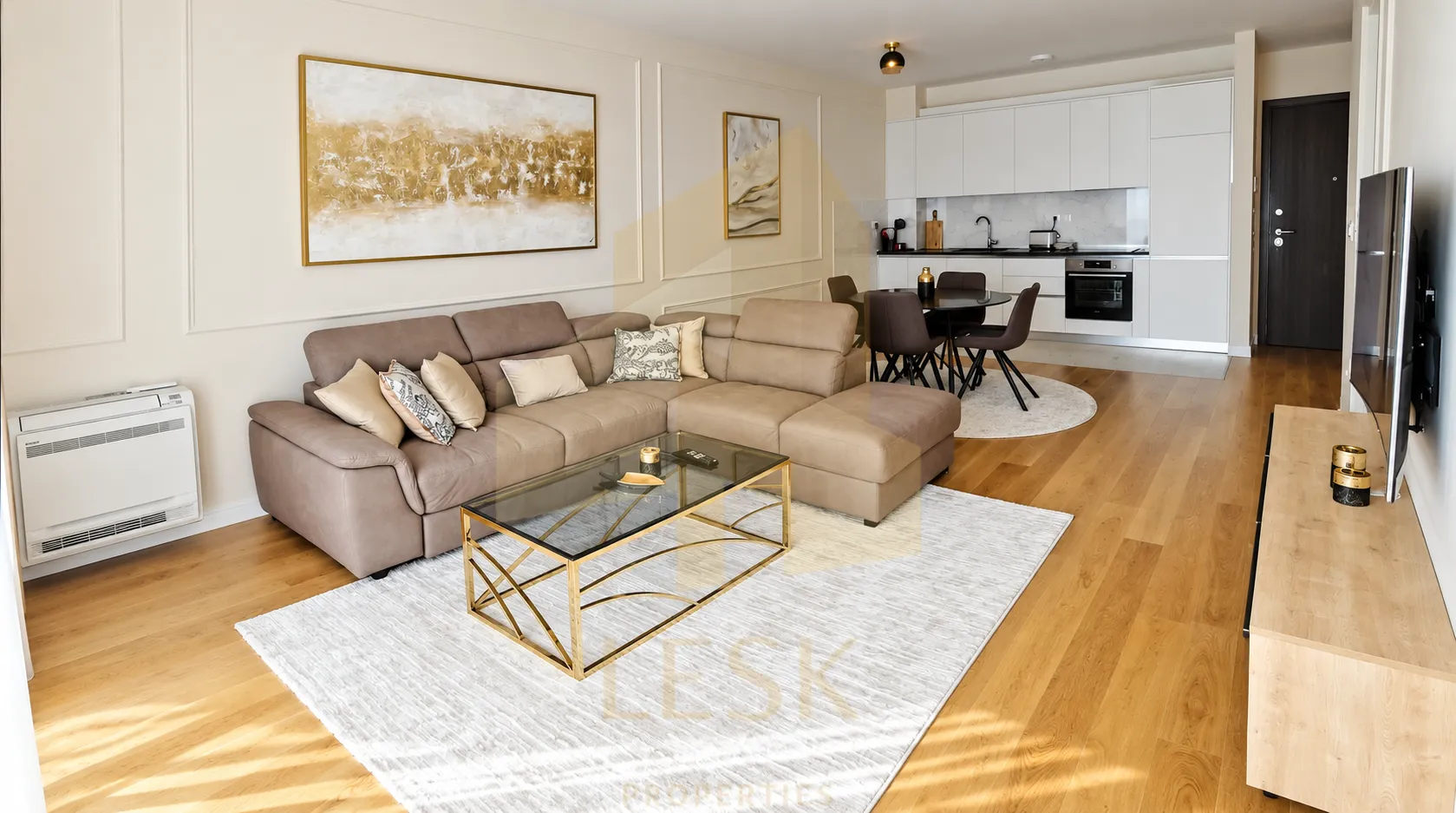 Modern living room with a sofa connected to the dining area and kitchen.