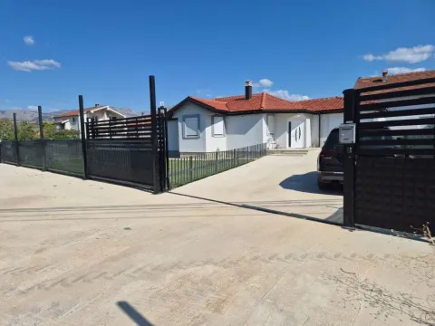 View of the exterior of the house with a fence and a gate. - image 11