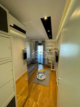 Small living room with a sofa, coffee table, and access to the terrace. - image 7