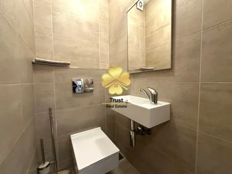 Small tiled bathroom with a washbasin and toilet. - image 13